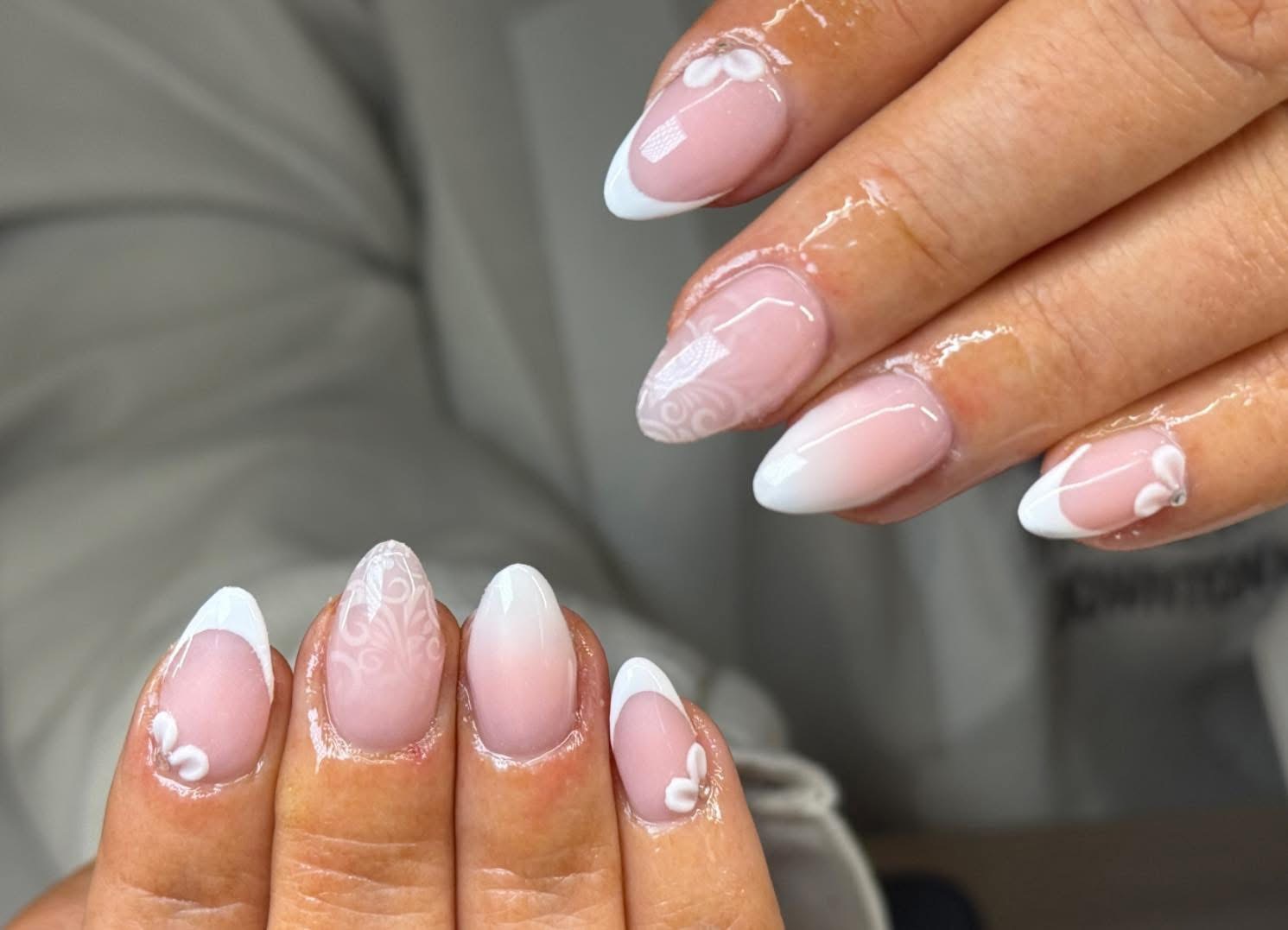 Soft white French nails with delicate floral details